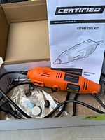 Rotary tool with accessories and manual in box