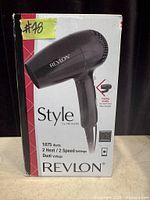 Front of retail box displaying Revlon Style folding handle 1875-watt hair dryer
