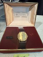 Watch in open Bulova box, dial and strap visible