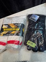 Package of Workload socks and bagged winter gloves side by side