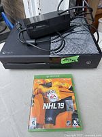 Xbox One console, power supply, NHL 19 game case front