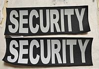 two reflective SECURITY patches displayed flat