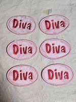 Six identical oval "Diva" patches arranged in two columns on light surface