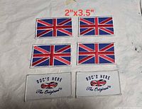 All six patches laid out on neutral surface showing designs and size reference text