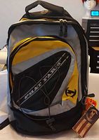 Front view of backpack showing colors, logo, tags attached