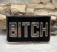 front view showing raised "BITCH" lettering on black background