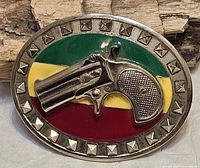 Front view showing gun motif, enamel colours and studded border