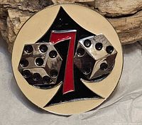 Front of belt buckle showing spade, 7 and dice design