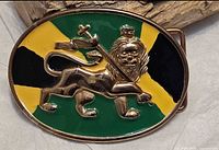 Front of oval belt buckle showing Lion of Judah on green-gold-black enamel background