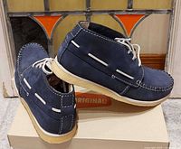 Pair of navy suede Clarks Originals shoes on box, side and rear view
