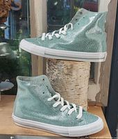 Side view of both sneakers showing color, texture, and lacing