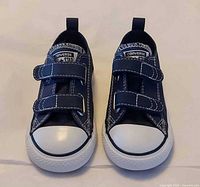 Pair of navy Converse infant sneakers front view
