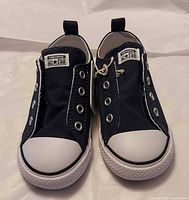 Front view of both navy blue Converse infant slip-on sneakers