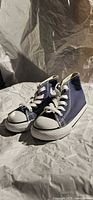 Pair of navy Converse infant high-tops angled view showing toe caps and laces
