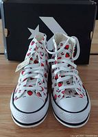 Front view of both sneakers with box