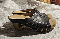 Left side view of pair showing leather upper cutouts and wooden heel