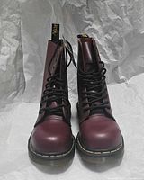 Front view of cherry red Dr. Martens boots standing upright showing laces, toe caps and overall condition