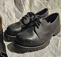 Angled view of left sides showing leather uppers, laces, and overall form