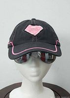 Front view showing pink Superman logo patch and brim trim