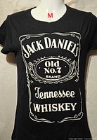 Front view of black Jack Daniel's Old No.7 Tennessee Whiskey graphic T-shirt, girls size M