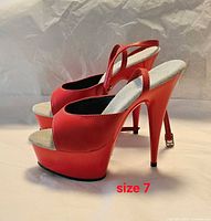 Side view of both sandals showcasing color, platform and heel