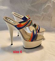 Side view of both sandals showing rainbow straps, white platforms, stilettos and size marking