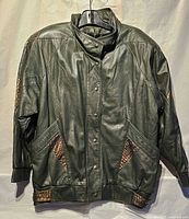 Full front view of leather jacket showing overall design and reptile insets
