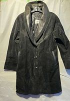 Front view of black suede leather long jacket on hanger