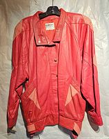 Front view of red leather jacket with beige accents