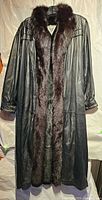 Front view of black leather coat with mink fur trim