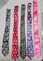 Five ties laid out: gray skull Santa, red skull, black swirl skull, blue heart skull, pink micro-print