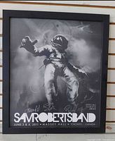 Front view of framed Sam Roberts Band poster showing artwork, signatures, frame