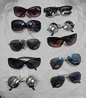 All ten sunglasses laid out on white background