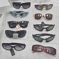All ten pairs of sunglasses displayed in two columns on tissue paper