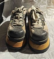 Front view of both platform shoes showing uppers, laces, toe wear