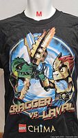 Front view of black youth medium LEGO Chima T-shirt showing Cragger vs Laval graphic