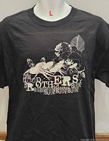 Front view of black T-shirt with graphic print and size indicator