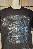 Front view of black T-shirt showing full fantasy cyborg demon graphic and size L indication