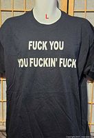 Front view of black graphic T-shirt displaying text and size indicator