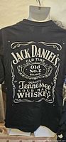 Front view of black Jack Daniel's graphic T-shirt on hanger