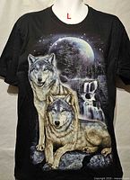 Front view of black T-shirt with wolves and moon graphic, size L