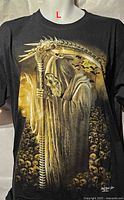 Front view of black T-shirt on mannequin showing Grim Reaper artwork and size indicator L