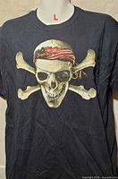 Front view of black T-shirt with pirate skull and crossbones graphic
