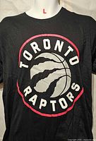 Front view showing Toronto Raptors logo on black T-shirt