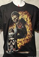 Front of black T-shirt showing skeleton skateboarder and flames