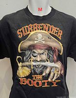 Front view of black T-shirt showing full pirate graphic and text