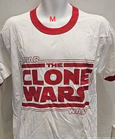 Front view of white ringer T-shirt showing red graphic and red collar/cuffs