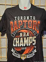 Front view of black Toronto Raptors 2019 NBA Champions men’s medium T-shirt