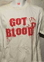 Front view of off-white T-shirt displaying red “GOT BLOOD” graphic and size reference M