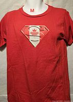 Front view of red Superman maple leaf graphic T-shirt on mannequin